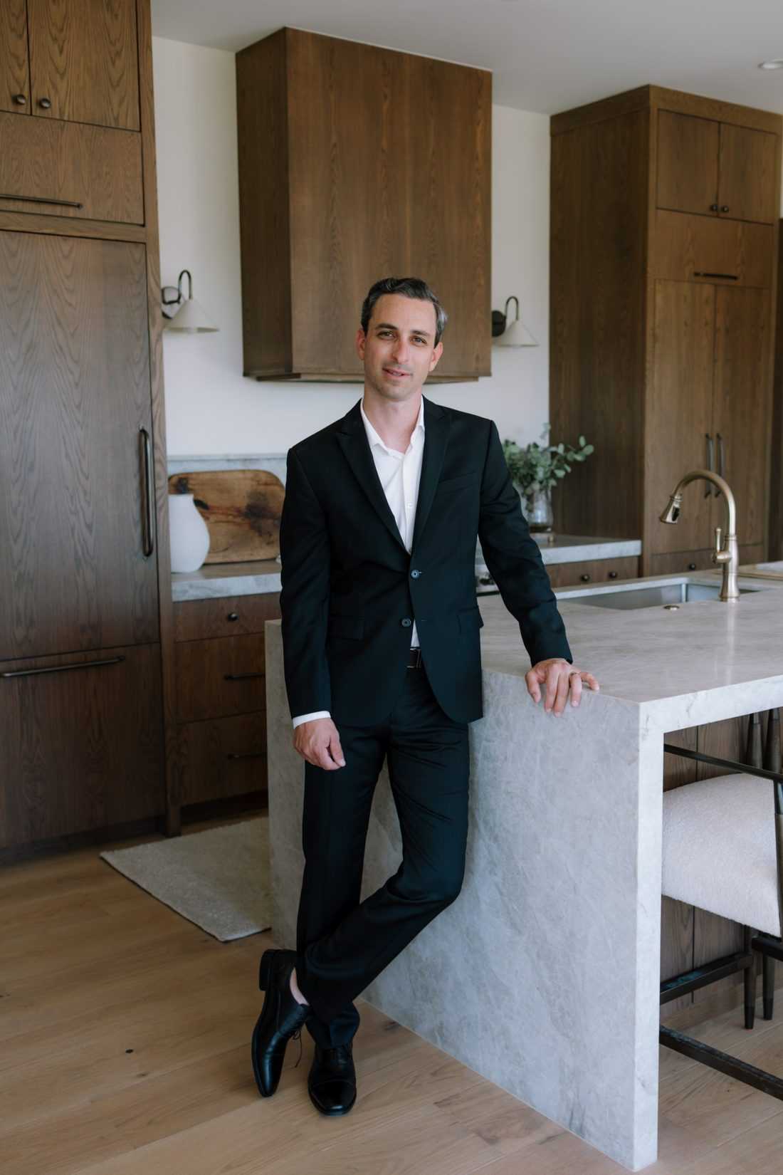Aaron Benson standing at a marble kitchen island